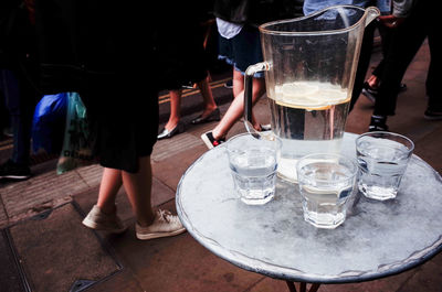 Low section of people standing on table at restaurant