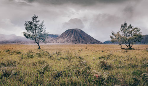 Scenic view of mountains against cloudy sky