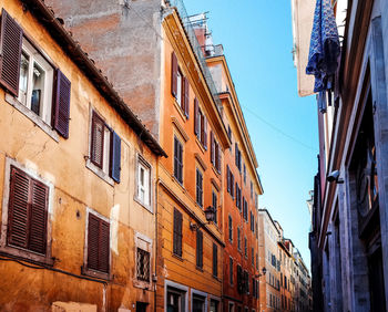 Low angle view of street buildings against clear sky