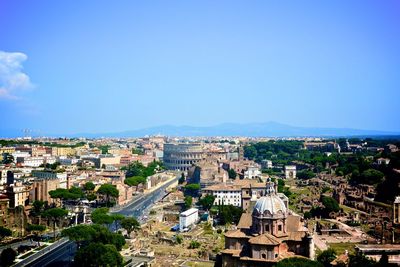 View of cityscape against blue sky