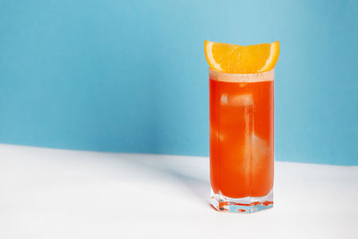 Close-up of drink in glass against blue background