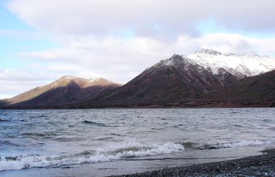 Scenic view of mountains against cloudy sky