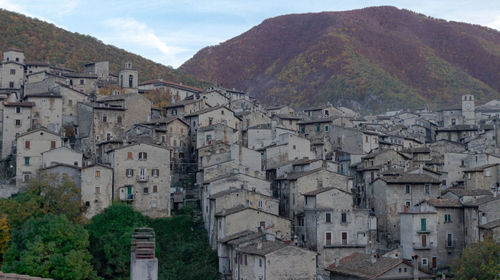 Buildings in town against sky