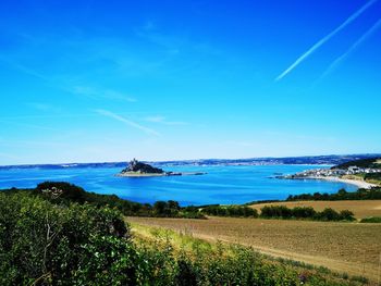 Scenic view of sea against blue sky