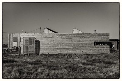 Built structure on field against clear sky