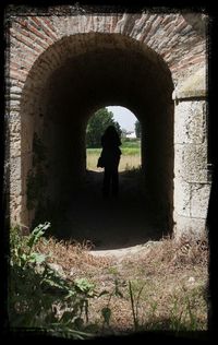 Woman walking in tunnel
