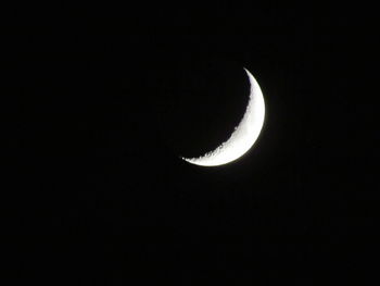 Low angle view of half moon against sky at night