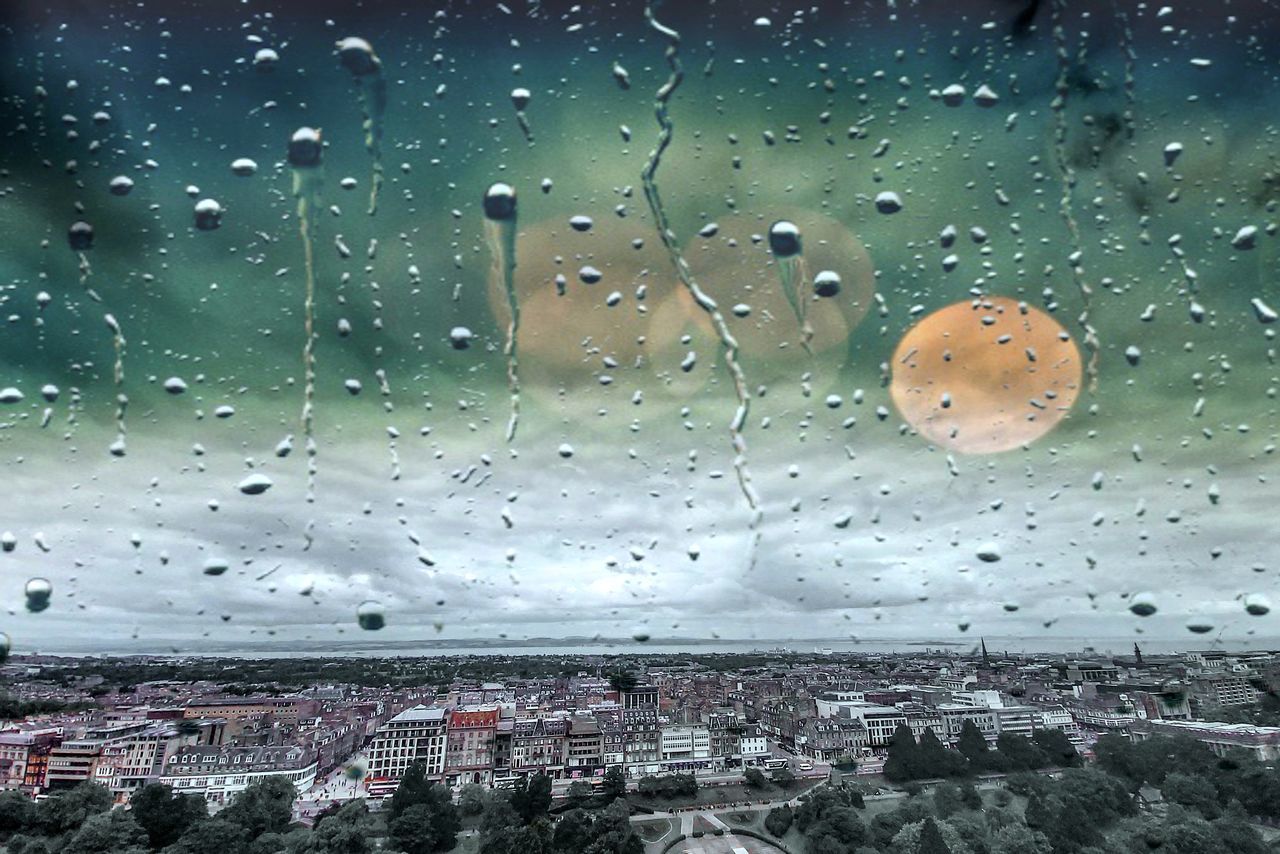 WATER DROPS ON GLASS WINDOW IN CITY