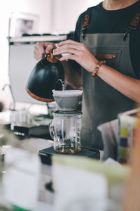 Man pouring coffee in cup