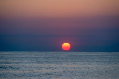 Scenic view of sea against romantic sky at sunset