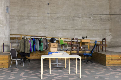 Furniture and recycled clothes arranged in recycling center