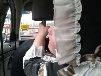 Low section of man sitting in train