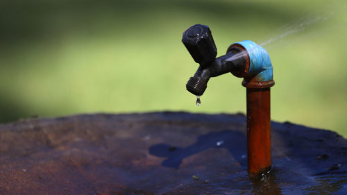 Close-up of faucet in water