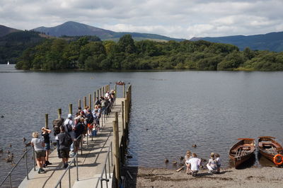 High angle view of people on shore against sky