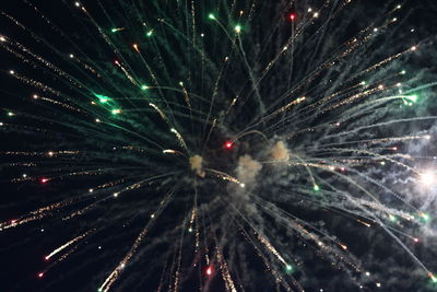 Low angle view of firework display at night