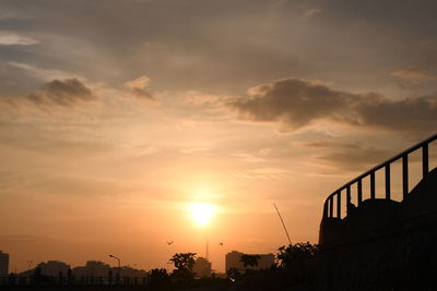Silhouette bridge against sky during sunset