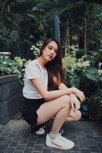 Portrait of young woman sitting outdoors