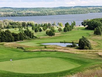 Scenic view of golf course against sky