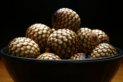 Close-up of eggs in bowl against black background