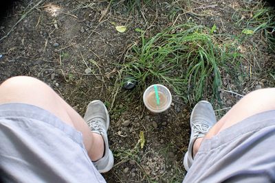 Low section of man standing on field