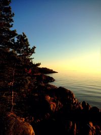 Scenic view of sea against clear sky during sunset