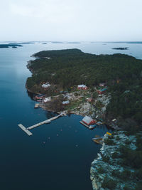 High angle view of sea by buildings against sky