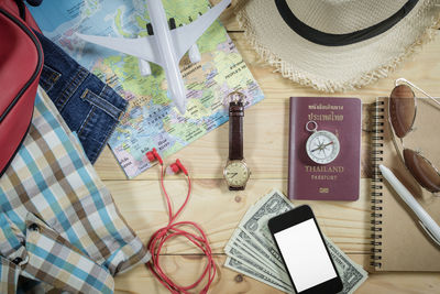 High angle view of mobile phone and book on table
