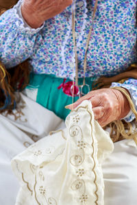 Midsection of woman sewing textile