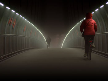 View of man in illuminated tunnel