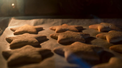 Christmas cookies baking in the oven. christmas baking. gingerbread biscuits on baking tray.