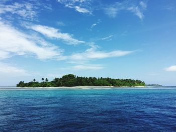 Scenic view of calm sea against cloudy sky