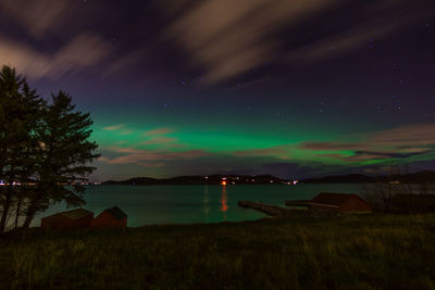 Scenic view of lake against sky at night