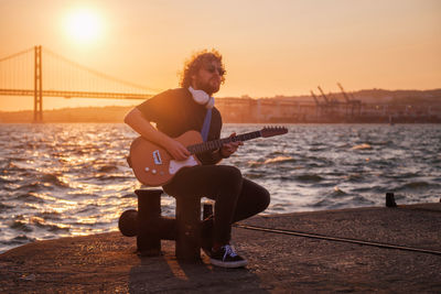 Street musician playing electric guitar in the street