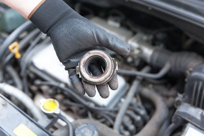 High angle view of mechanic repairing car