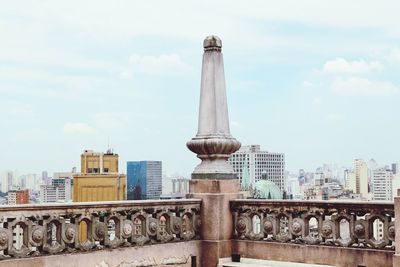 Sculpture of building against cloudy sky