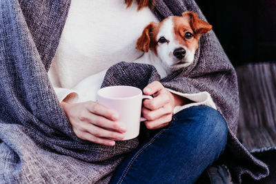 Midsection of woman holding dog