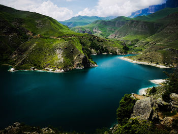 High angle view of sea and mountains against sky