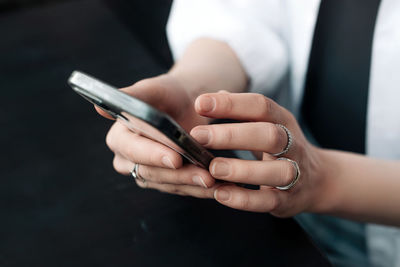 Midsection of man using mobile phone