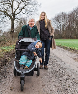 Portrait of multi-generation family on field