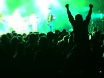 Silhouette people enjoying music concert