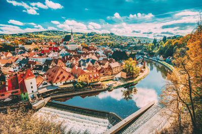 High angle view of townscape by river against sky