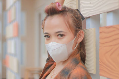 Close-up of young woman wearing mask
