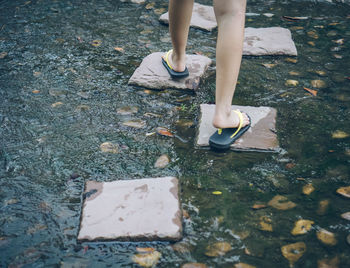 Low section boy walking on stone