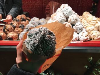 Cropped hand having sweet food in store