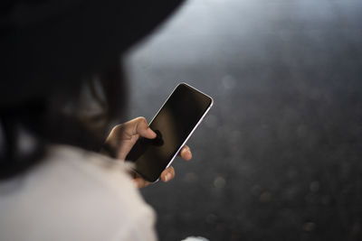 Midsection of man using mobile phone