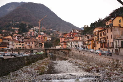 River amidst buildings in town against clear sky