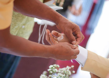 Midsection of couple holding hands