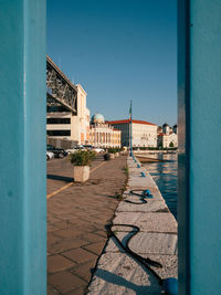 Visitors stroll along the charming waterfront of trieste, enjoying the beautiful architecture