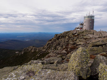 Surrounded by rocks, a building stands on the top of whiteface mountain new york state, usa.