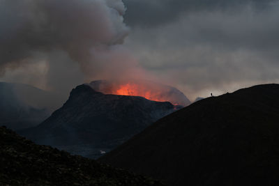 Smoke emitting from volcanic mountain against sky